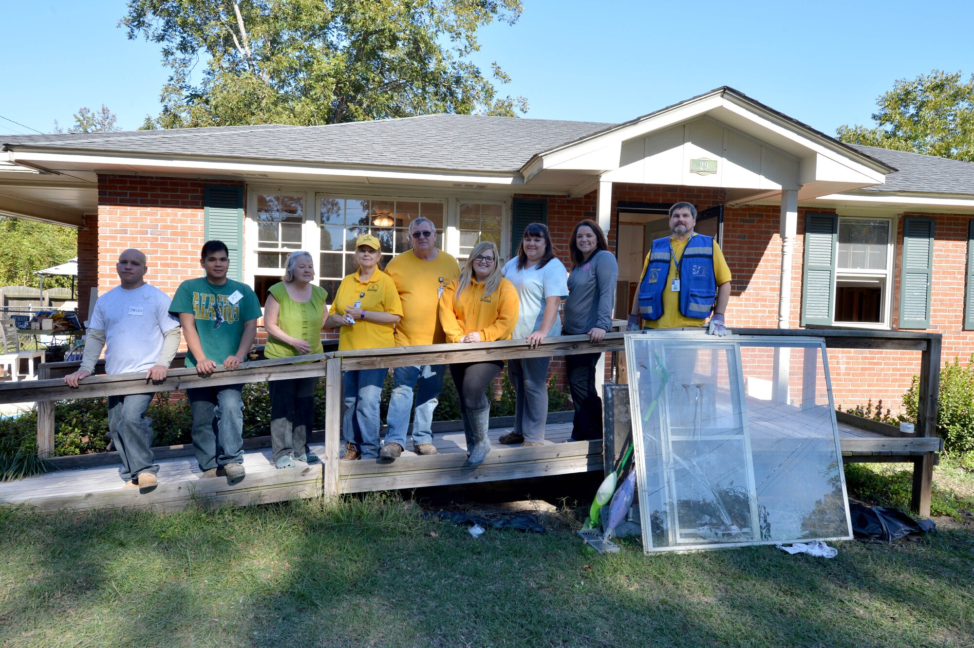 U.S. Air Force Airmen assigned to the 20th Fighter Wing and Southern Baptist Convention disaster relief members from Kentucky stand with homeowner Susan Bell during a disaster relief effort in Sumter, S.C., Oct. 19, 2015. Bell’s home was damaged by a flood caused by the storm resulting from Hurricane Joaquin, Oct. 4-5. (U.S. Air Force photo by Senior Airman Diana M. Cossaboom/Released)