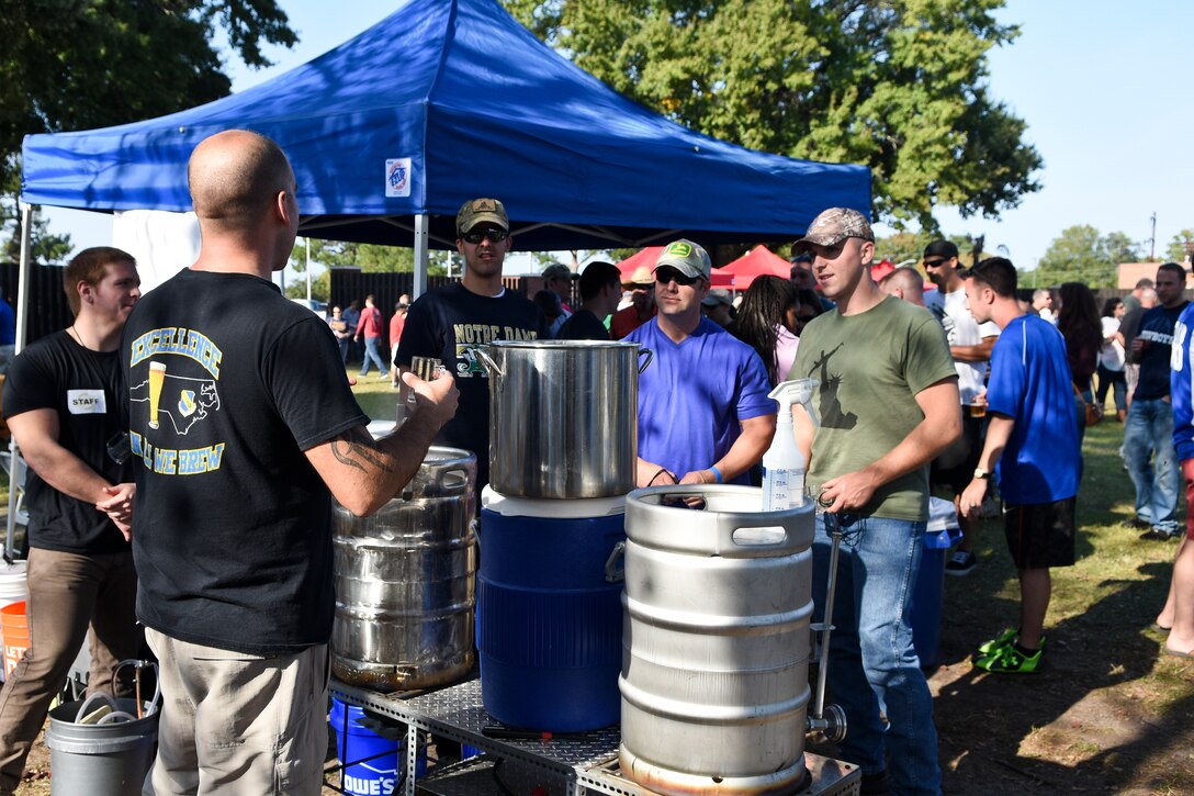 First Lt. Ryan DeLine, 4th Equipment Maintenance Squadron maintenance flight commander, explains how to brew beer during Oktobrewfest, Oct. 24, 2015, at Seymour Johnson Air Force Base, North Carolina. DeLine, a member of the SJ Home Brew Club, brewed five gallons of beer during the event. (U.S. Air Force photo/Senior Airman Aaron J. Jenne)