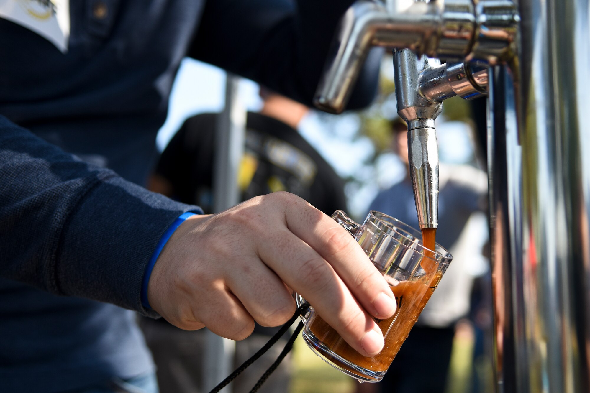 Senior Airman Skyler Tennant, 4th Force Support Squadron fitness and sports journeyman, pours a beer sample made by the SJ Home Brew Club during Oktobrewfest, Oct. 24, 2015, at Seymour Johnson Air Force Base, North Carolina. The event featured samplings from a selection of 40 local beers, including six made by the club. (U.S. Air Force photo/Senior Airman Aaron J. Jenne)