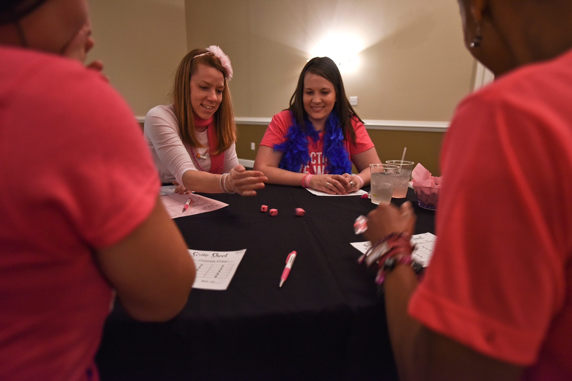 Lori Carter (left) and Brandi Haba (right), members of the Officers and Civilian Spouses Club, roll dice Oct. 23, 2015, at Seymour Johnson Air Force Base, North Carolina, during a Bunco for Breast Cancer event. More than 50 members attended the event, which raised funds for the Combined Federal Campaign. (U.S. Air Force photo/Senior Airman Aaron J. Jenne)