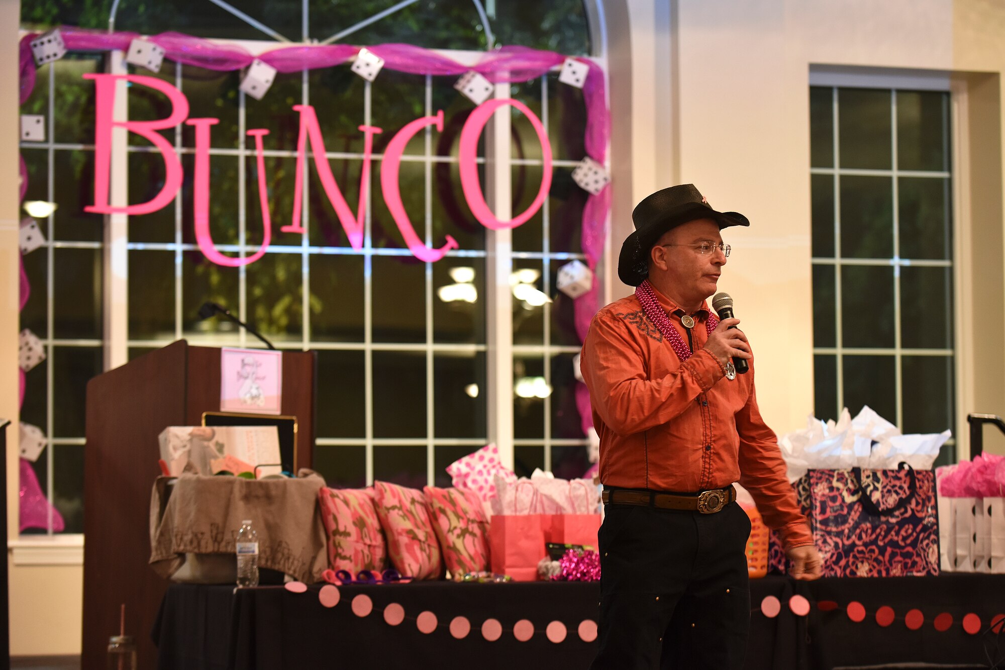 David Bernheim, a member of the Officers and Civilian Spouses Club, talks about how breast cancer affected his family Oct. 23, 2015, at Seymour Johnson Air Force Base, North Carolina, during a Bunco for Breast Cancer event. Bernheim, who lost two sisters to breast cancer, said lack of screening and denial forever changed his family. He urged the audience to take the topic seriously because their lives could depend on it. (U.S. Air Force photo/Senior Airman Aaron J. Jenne)