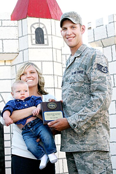 Staff Sgt. Luke Hinz poses for a photo with wife Chelsea and five-month old son Wyatt after receiving the Harvest Military Family Award at the Harvest Parade in Plattsmouth, Neb. Oct. 12. (Photo courtesy of Plattsmouth Journal)