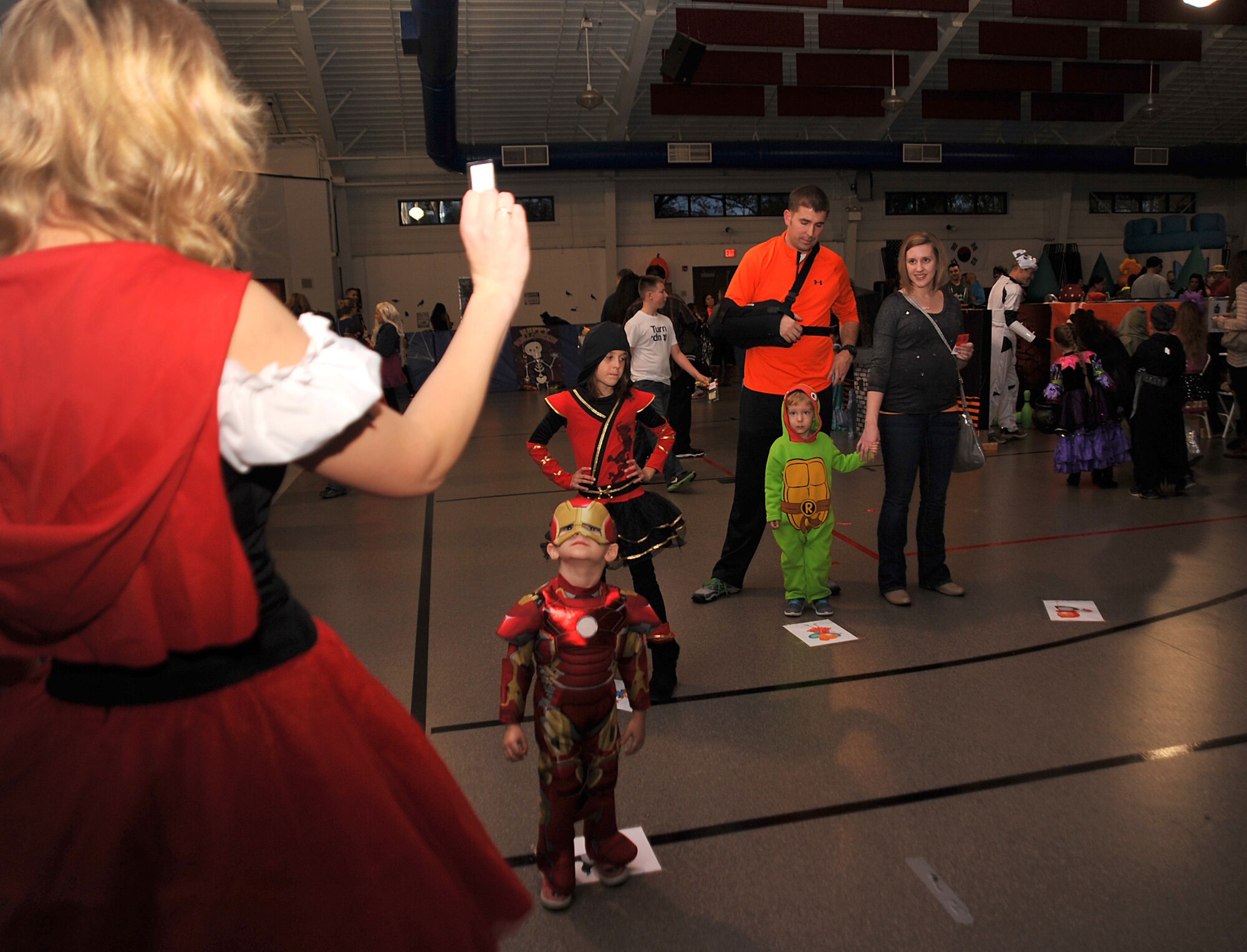 Senior Airman Desiree Economides, 319th Air Base Wing Public Affairs photojournalist, leads the candy walk at Liberty Scare on Grand Forks Air Force Base, North Dakota, Oct. 23, 2015. Liberty Scare is an annual event where service members can bring their families out to enjoy games and festivities in the spirit of Halloween. (U.S. Air Force photo by Airman 1st Class Bonnie Grantham/released)