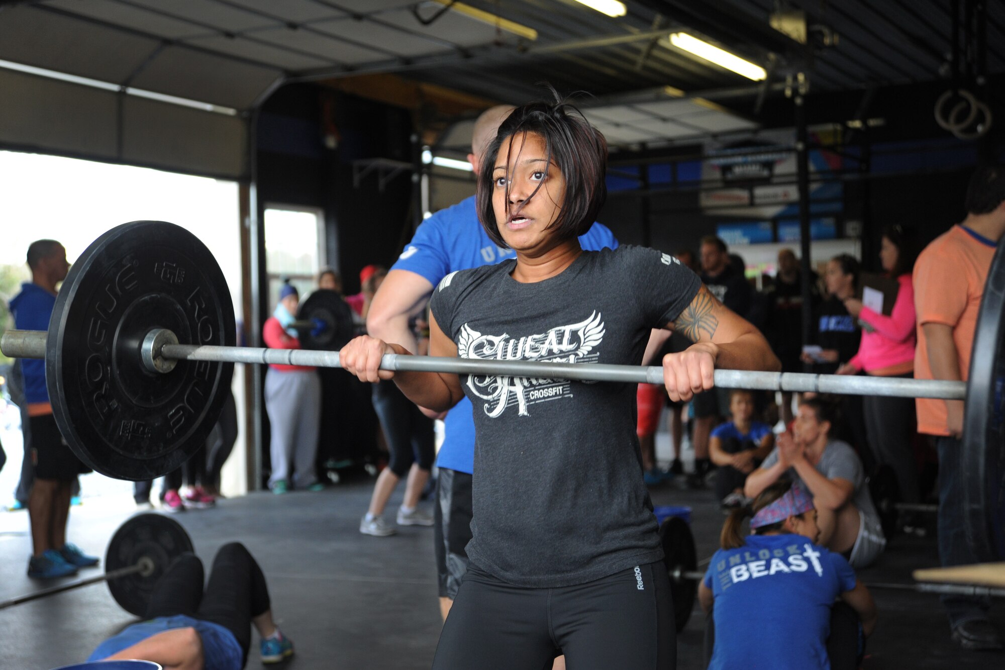 Senior Airman Nikki Mitchell, 436th Dental Squadron dental assistant, performs a hang clean during the second event of the Eastern Shore Affiliate Challenge Oct. 17, 2015, in Georgetown, Del. One of the best parts of the competition for Mitchell was pushing herself to her limits and cheering on her teammates. (U.S. Air Force photo/Staff Sgt. Elizabeth Morris)