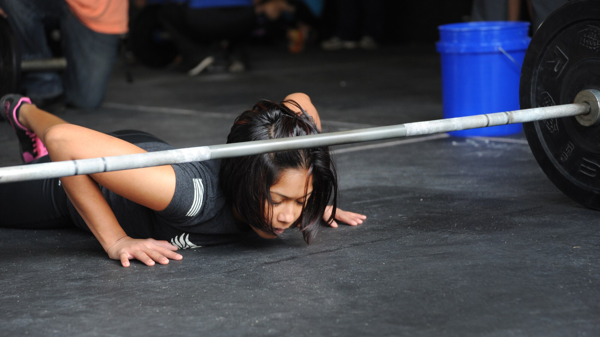 Senior Airman Nikki Mitchell, 436th Dental Squadron dental assistant, performs a burpee during the second event of the Eastern Shore Affiliate Challenge Oct. 17, 2015, in Georgetown, Del. Mitchell started doing CrossFit a year ago and it has helped her become stronger both mentally and physically. (U.S. Air Force photo/Staff Sgt. Elizabeth Morris)