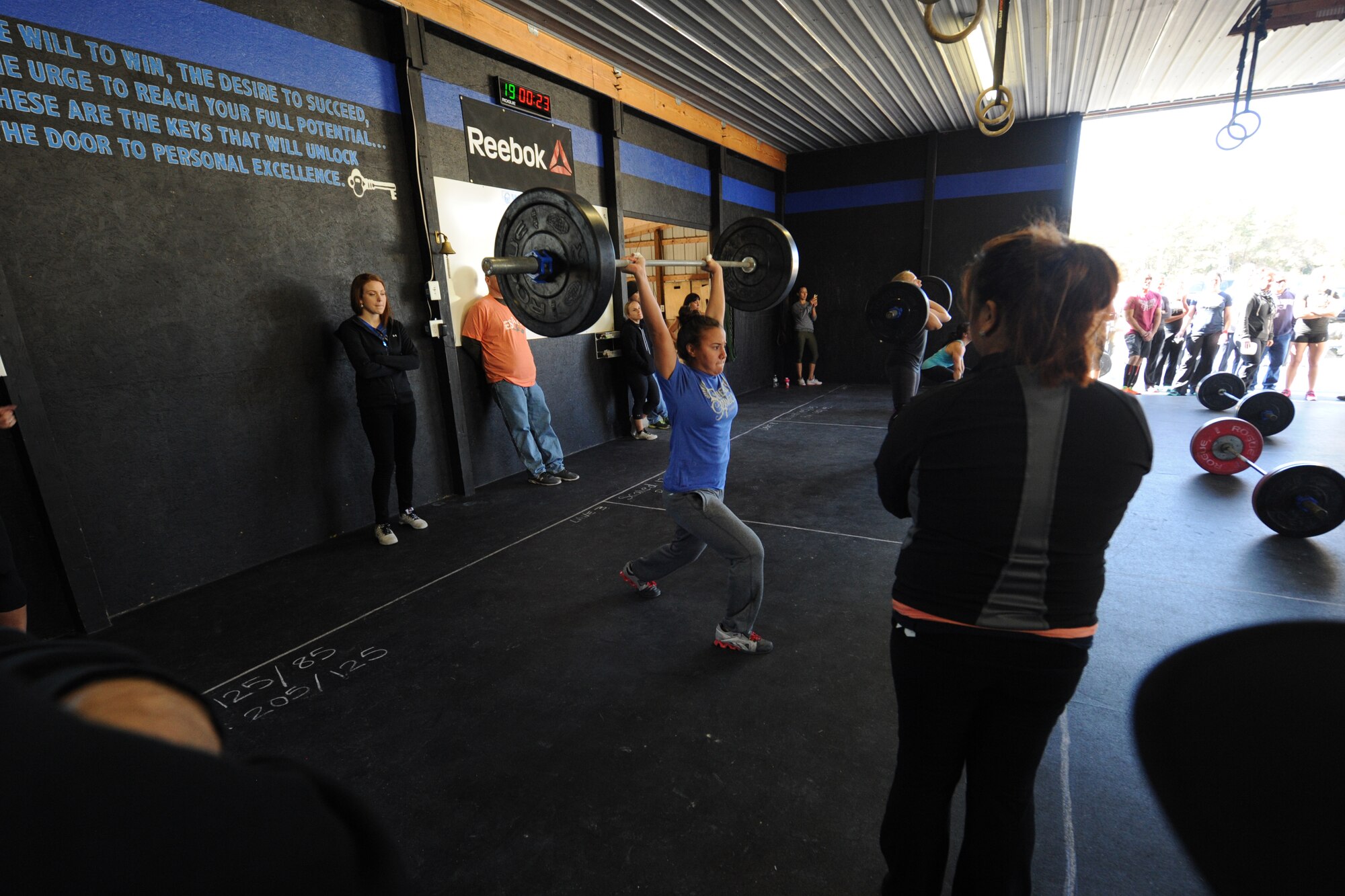 Airman 1st Class Karla Montes, 436th Dental Squadron dental assistant, performs a clean and jerk during the Eastern Shore Affiliate Challenge Oct. 17, 2015, in Georgetown, Del. Montes went on to compete in a group challenge based on her individual scores throughout the competition. (U.S. Air Force photo/Staff Sgt. Elizabeth Morris)