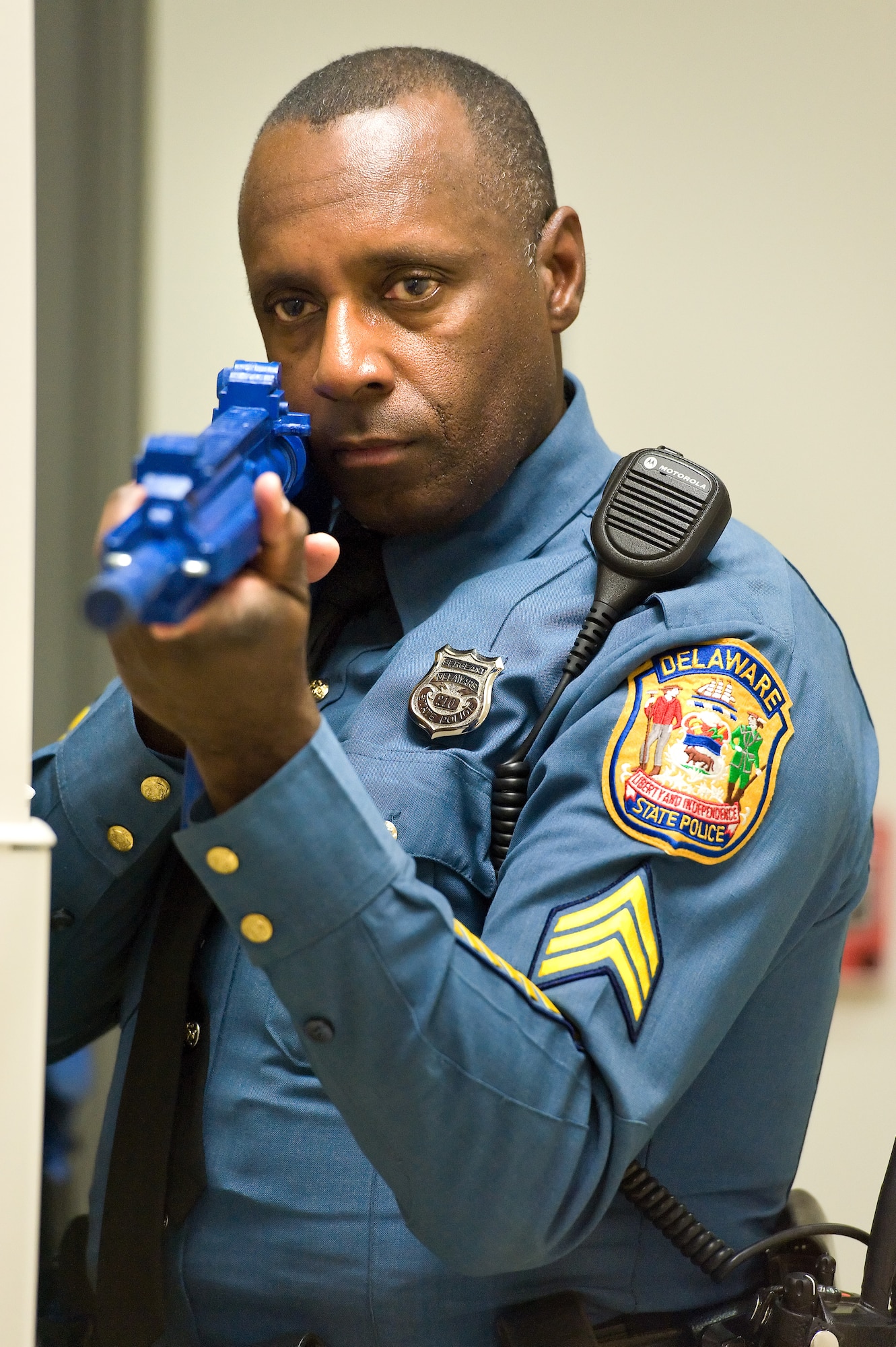 Sgt. Bruce Harris, Delaware State Police, Troop 3, Camden, Del., stands guard during a simulated active shooter scene as part of the major accident response exercise Oct. 20, 2015, on Dover Air Force Base, Del. During the 3-day-long MARE, military and civilian first responders dealt with numerous scenarios that tested their response time, skills and inter-agency teamwork. Harris, a field training officer with the DSP, was part of a five-member team that swept the first and second floors of the north end of building 639. (U.S. Air Force photo/Roland Balik)