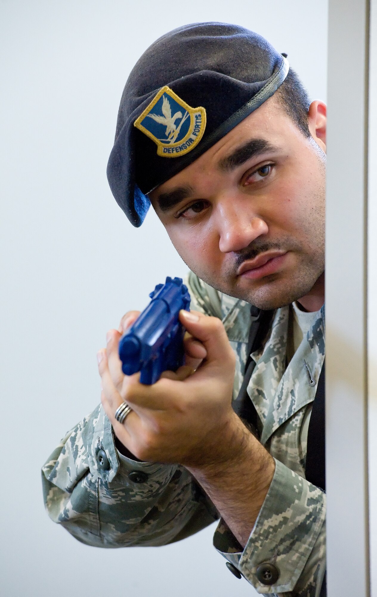 Staff Sgt. Christopher Walker, 436th Security Forces Squadron response force leader, peeks around a cubicle wall during a simulated active shooter scene Oct. 20, 2015, in building 639 on Dover Air Force Base, Del. Walker, along with law officers from the Dover Police Department, Dover, Del.; the Delaware State Police, Troop 3, Camden, Del.; and 436th SFS personnel, initiated a sweep of the building's first and second floors and warehouse areas. (U.S. Air Force photo/Roland Balik)