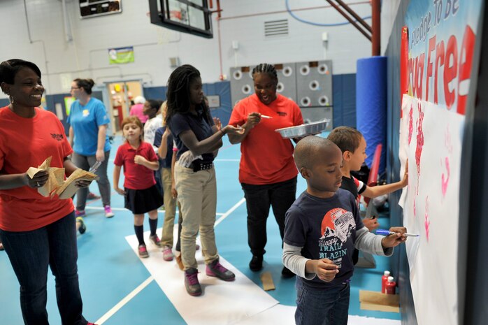 Children with the youth center paint their hands to signify their pledge to be drug free at the youth center, Joint Base Charleston, S.C., Oct. 23, 2015. The annual Red Ribbon Week campaign began with more than 20 children reciting an oath to be drug free and signing with their hand print. (U.S. Air Force photo/Tech. Sgt. Renae Pittman)