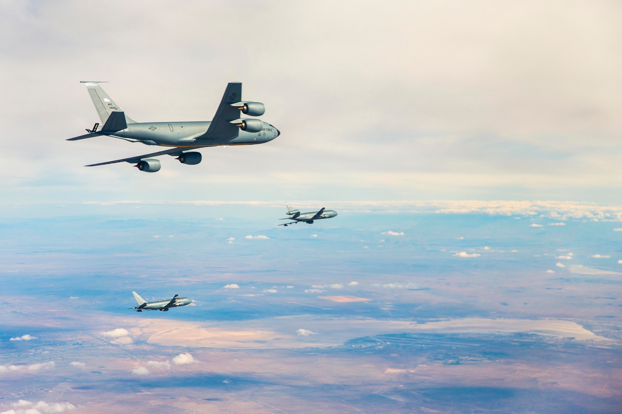 A KC-135 Stratotanker from Fairchild Air Force Base flies in formation with the KC-46 program's first test aircraft, a Boeing 767-2C (EMD-1), that departed from its home station at Boeing Field in Seattle and touched down at Edwards Air Force Base, Calif. for the first time Oct. 15. Boeing and the 418th Flight Test Squadron at Edwards AFB, are conducting Ground Effects and Fuel Onload Fatigue testing on the new tanker. (U.S. Air Force photo/Christopher Okula)