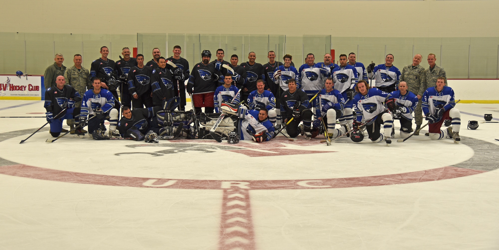 The Fairchild Air Force Base Falcons Varsity Hockey team poses for a team picture after the Blue and White Game Oct. 23, 2015, at Eastern Washington University’s Recreation Center ice rink in Cheney, Wash. The blue team, coached by Col. Brian McDaniel, 92nd Air Refueling Wing commander, and Chief Master Sgt. Christian Pugh, 92nd ARW command chief, claimed the win against the white team, five to three. (U.S. Air Force photo/Airman 1st Class Mackenzie Richardson)