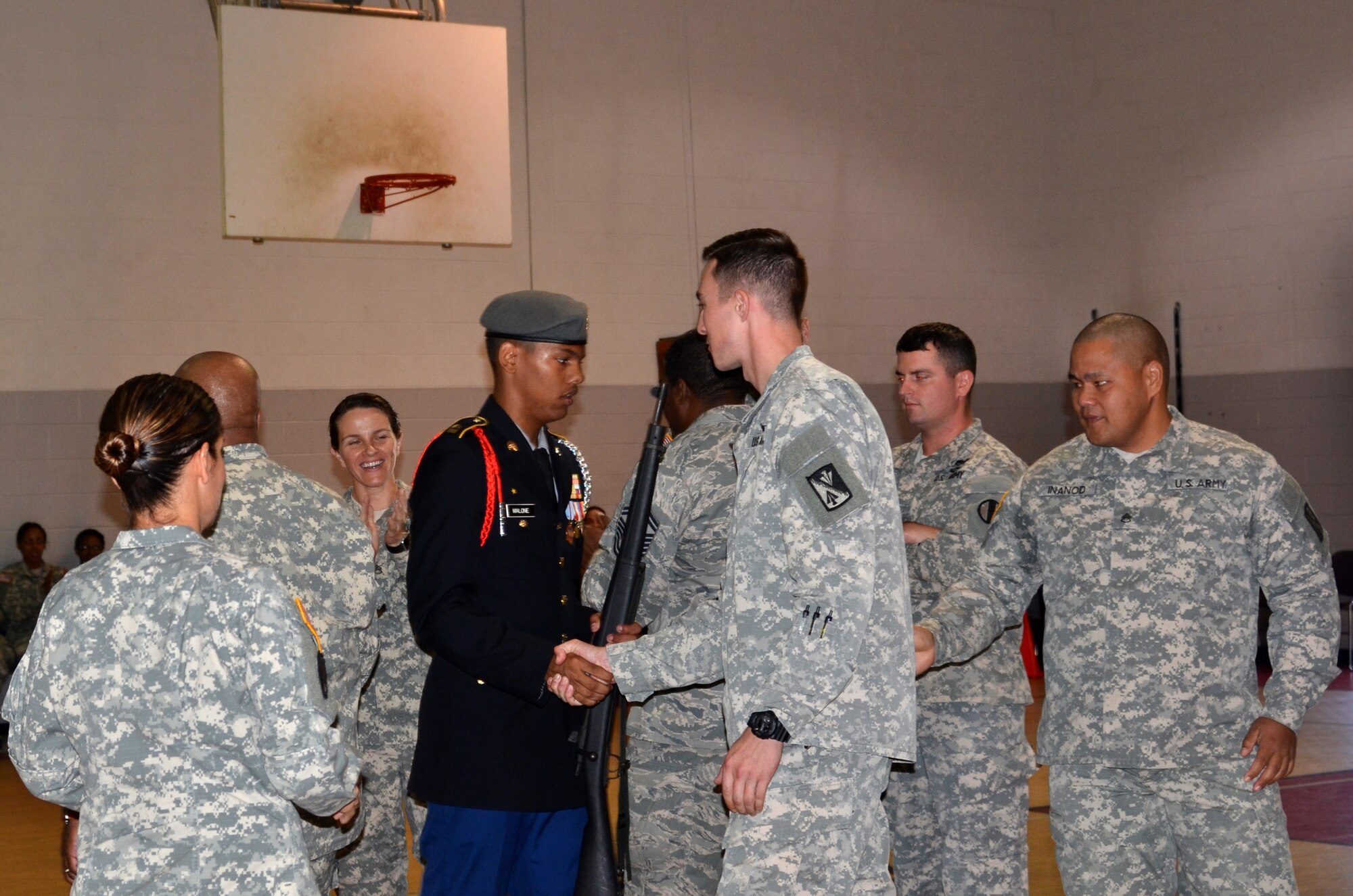 Joint Base Langley-Eustis service members congratulate Raymond Malone, Smithfield High School Army Junior ROTC cadet, for winning the armed “knock-out drill” portion of the competition during the Hampton Roads Junior ROTC Drill Competition at Northampton Community Center in Hampton, Va., Oct. 24, 2015. The armed “knock-out drill” was one of eight different events cadets participated in. (U.S. Air Force photo by Master Sgt. April Wickes/Released)