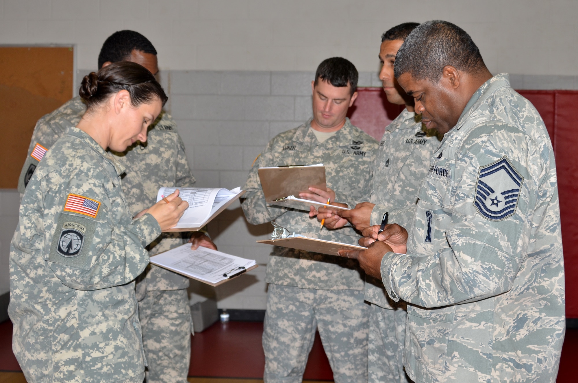 Joint Base Langley-Eustis service members compile their scores after a uniform inspection during the Hampton Roads Junior ROTC Drill Competition at Northampton Community Center in Hampton, Va., Oct. 24, 2015. Seven Junior ROTC units competed, with Bethel High School’s Army Junior ROTC winning the overall competition. (U.S. Air Force photo by Master Sgt. April Wickes/Released)