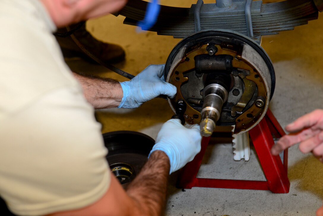 A U.S. Air Force Airman repairs the brakes of a Munition Handling Unit at Langley Air Force Base, Va., Oct. 19, 2015. The training is accompanied by periodic inspections to ensure Airmen know their job. (U.S. Air Force photo by Airman 1st Class Derek Seifert/ Released)