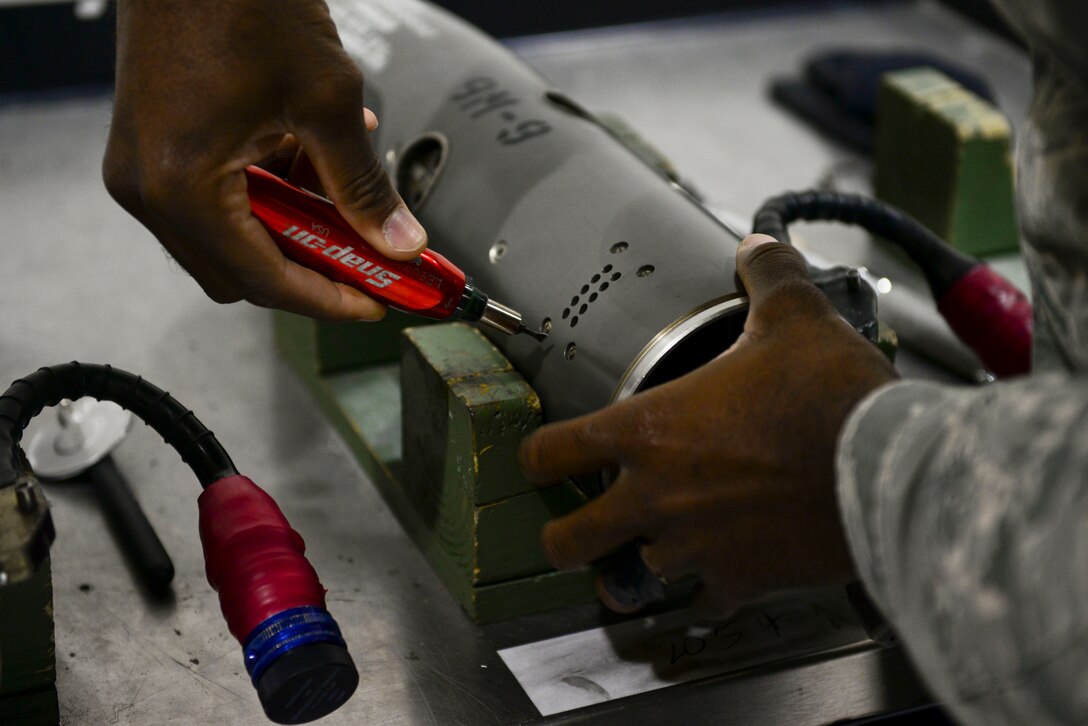 A U.S. Air Force Airman inspects a Guidance Control Section of a training missile at Langley Air Force Base, Va., Oct. 19, 2015. The Airman inspected the GCS for erosion and tightened the screws to ensure functionality. (U.S. Air Force photo by Airman 1st Class Derek Seifert/ Released)