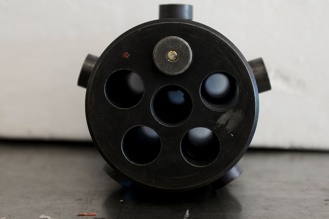 A 20 millimeter round is measured and examined at Langley Air Force Base, Va., Oct. 19, 2015. The round was put into the simulated cannon to inspect the casing ensuring there is no damage. (U.S. Air Force photo by Airman 1st Class Derek Seifert/ Released)
