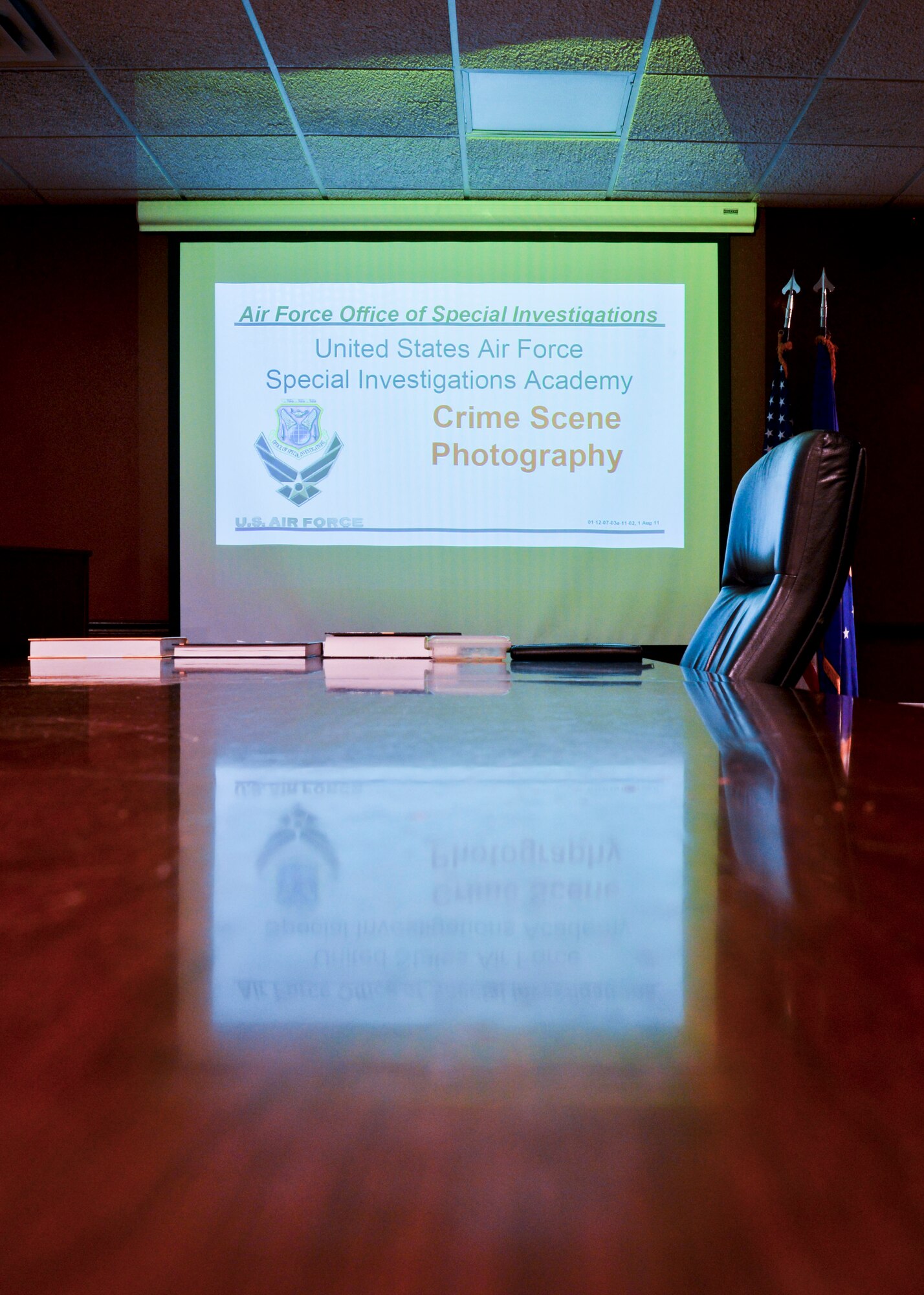 The Office of Special Investigations presents a slide show on crime scene photography at Minot Air Force Base, N.D., Oct. 22, 2015. OSI agents led training to share their process for photographing a crime scene. (U.S. Air Force photo/Airman 1st Class J. T. Armstrong)