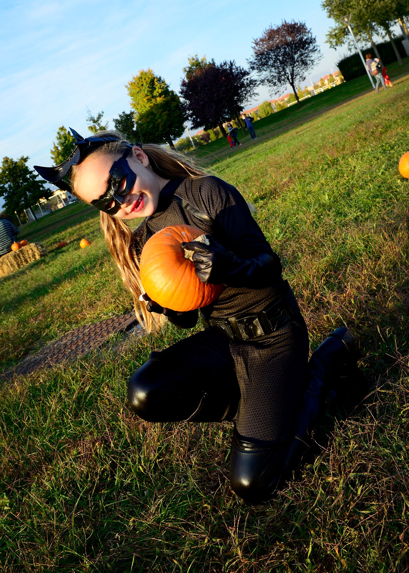 Olivia Donner picks a pumpkin during “Fall Fest,” Oct. 24, 2015, at Aviano Air Base, Italy. Team Aviano members and the local community came together to celebrate Halloween with children’s games, trick-or-treating, an outdoor movie and a haunted house. (U.S. Air Force photo by Senior Airman Areca T. Bell/Released)
