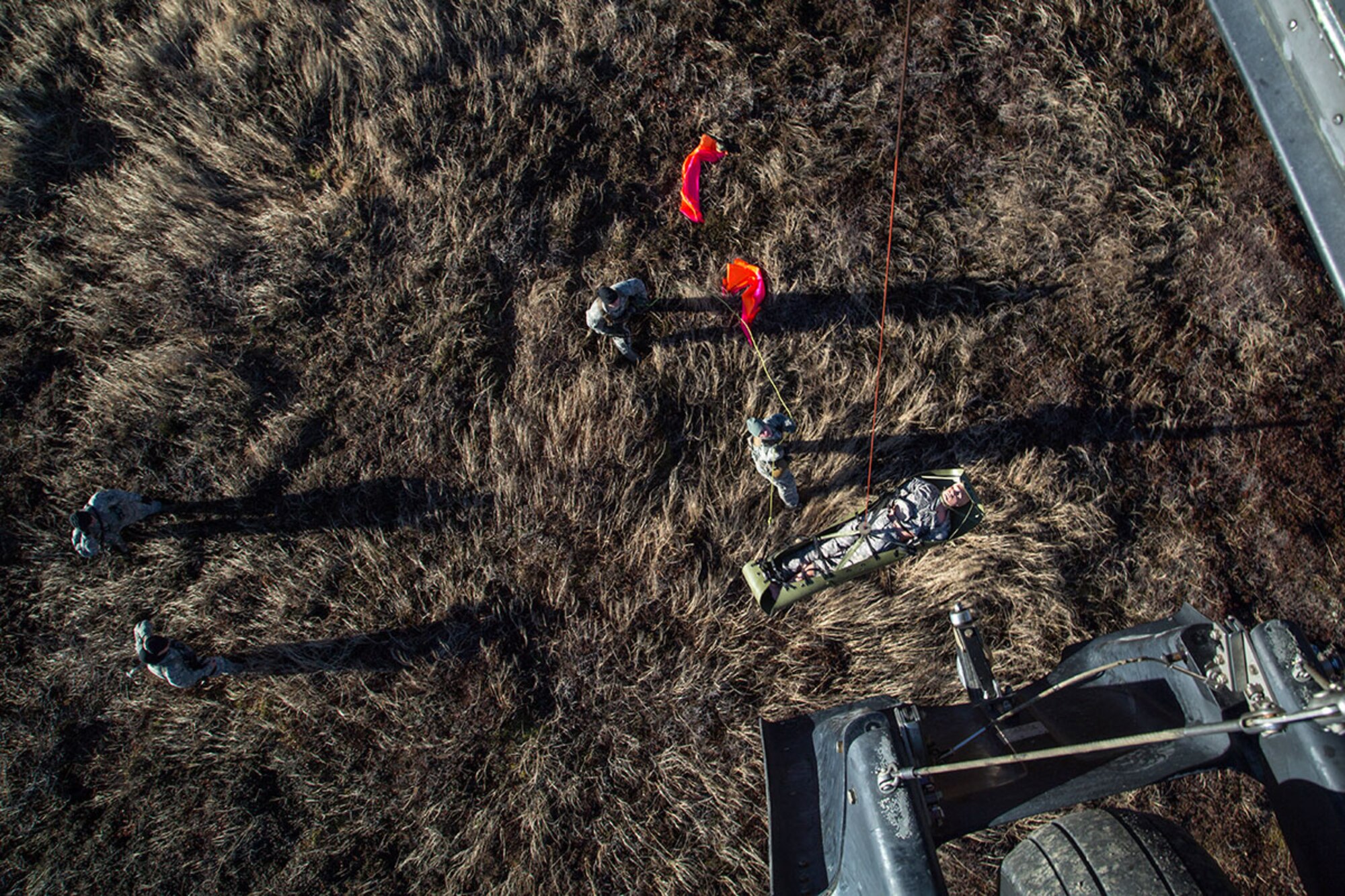U.S. Army Soldiers assigned to 1st Battalion (Airborne), 501st Infantry Regiment, guide a stretcher as it is hoisted up to a UH-60 Black Hawk helicopter assigned to 1st Battalion, 207th Aviation Regiment, while conducting casualty evacuation training on Joint Base Elmendorf-Richardson, Oct. 21, 2015. The CASEVAC training prepares units for future emergencies and maintains operational readiness. (U.S. Air Force photo/Alejandro Pena)