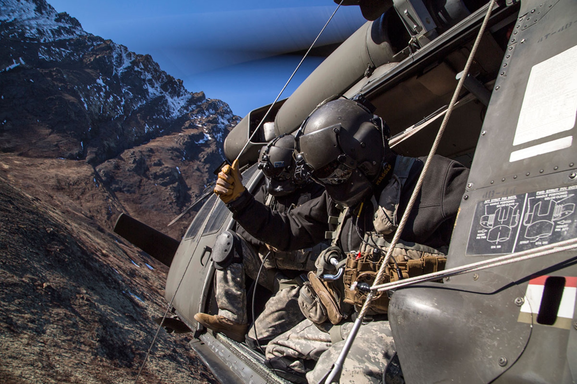 Alaska Army National Guard Staff Sgt. Bradley McKenzie, right, and Staff Sgt. Kevan Katkus, UH-60 Black Hawk helicopter crew chiefs assigned to 1st Battalion, 207th Aviation Regiment, prepare to hoist up a stretcher while conducting casualty evacuation training on Joint Base Elmendorf-Richardson, Oct. 21, 2015. The training, which also included deploying a jungle penetrator device, was coordinated with Soldiers assigned to 1st Battalion (Airborne), 501st Infantry Regiment. (U.S. Air Force photo/Alejandro Pena)