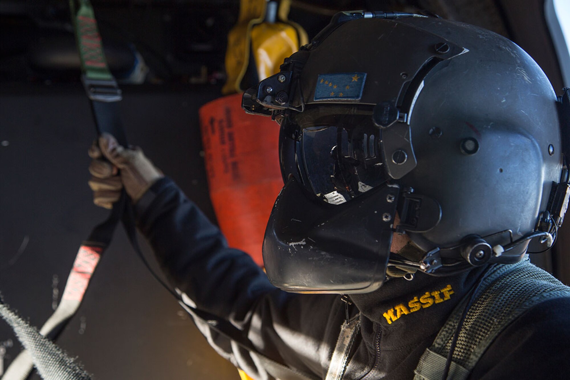 Alaska Army National Guard Staff Sgt. Kevan Katkus, a UH-60 Black Hawk helicopter crew chief assigned to 1st Battalion, 207th Aviation Regiment, conducts flight operations over Joint Base Elmendorf-Richardson, Alaska, Oct. 21, 2015. The flight operations included rescue hoist training and a casualty evacuation exercise with Soldiers assigned to 1st Battalion (Airborne), 501st Infantry Regiment. (U.S. Air Force photo/Alejandro Pena)