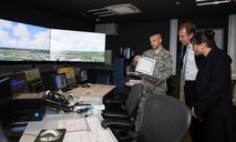 A 52nd Operations Support Squadron air traffic controller demonstrates the Air Traffic Control Simulator Equipment to Randolph Stich, Rhineland-Palatinate deputy minister of the interior and Elena Mazzola, German department liaison of military forces during a base tour Oct. 22, 2015, at Spangdahlem Air Base, Germany. Air traffic controllers use the ATCSE to simulate the view from the ATC tower, which gives them the ability to change weather conditions, visibility and time of day during take-offs and landings of aircraft. (U.S. Air Force photo by Staff Sgt. Christopher Ruano/Released)