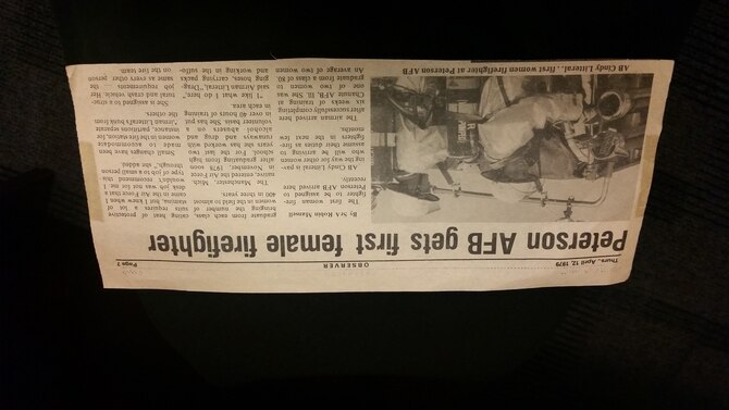 PETERSON AIR FORCE BASE, Colo. – A newspaper clipping from April 12, 1979 memorializes Peterson AFB’s first female firefighter, Deputy Chief Cindy Litteral. Litteral began her career as an enlisted Airman and retires from her civil service career as one of only 30 female deputy fire chiefs in the country. (U.S. Air Force photo by Lori O’Donley)