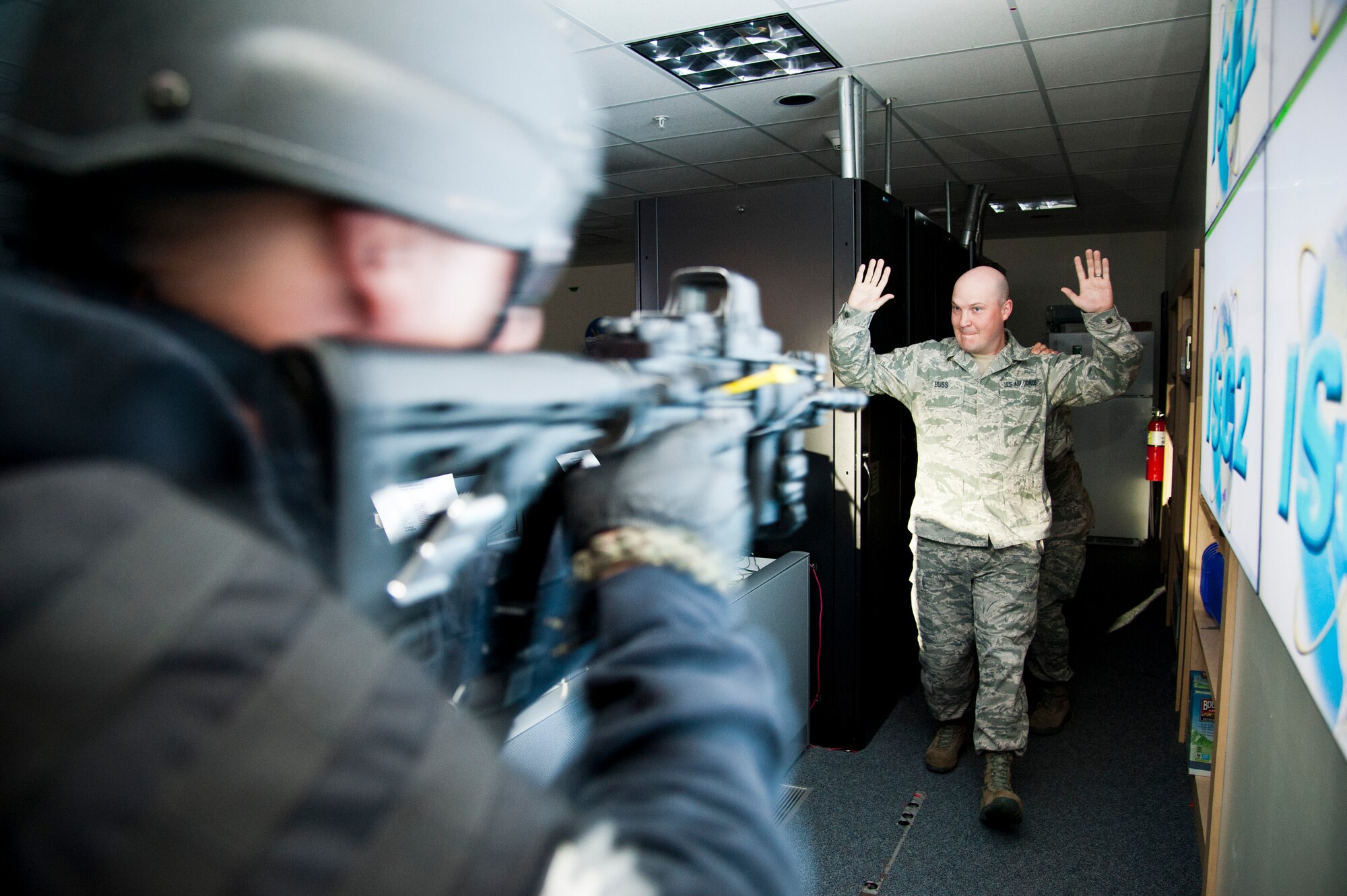 CHEYENNE MOUNTAIN AIR FORCE STATION, Colo. – First Lt. Miles Tran, simulated active shooter, hides behind Staff Sgt. Timothy Buss, simulated hostage, while El Paso County Sheriff’s SWAT Team breeches a mission center during a joint exercise, Oct. 22, 2015. The active shooter turned hostage exercise scenario was intended to evaluate the partnership between Cheyenne Mountain Air Force Station and El Paso County Sheriff’s Department in a training environment in preparation for potential real-world situations. (U.S. Air Force photo by Senior Airman Tiffany DeNault)