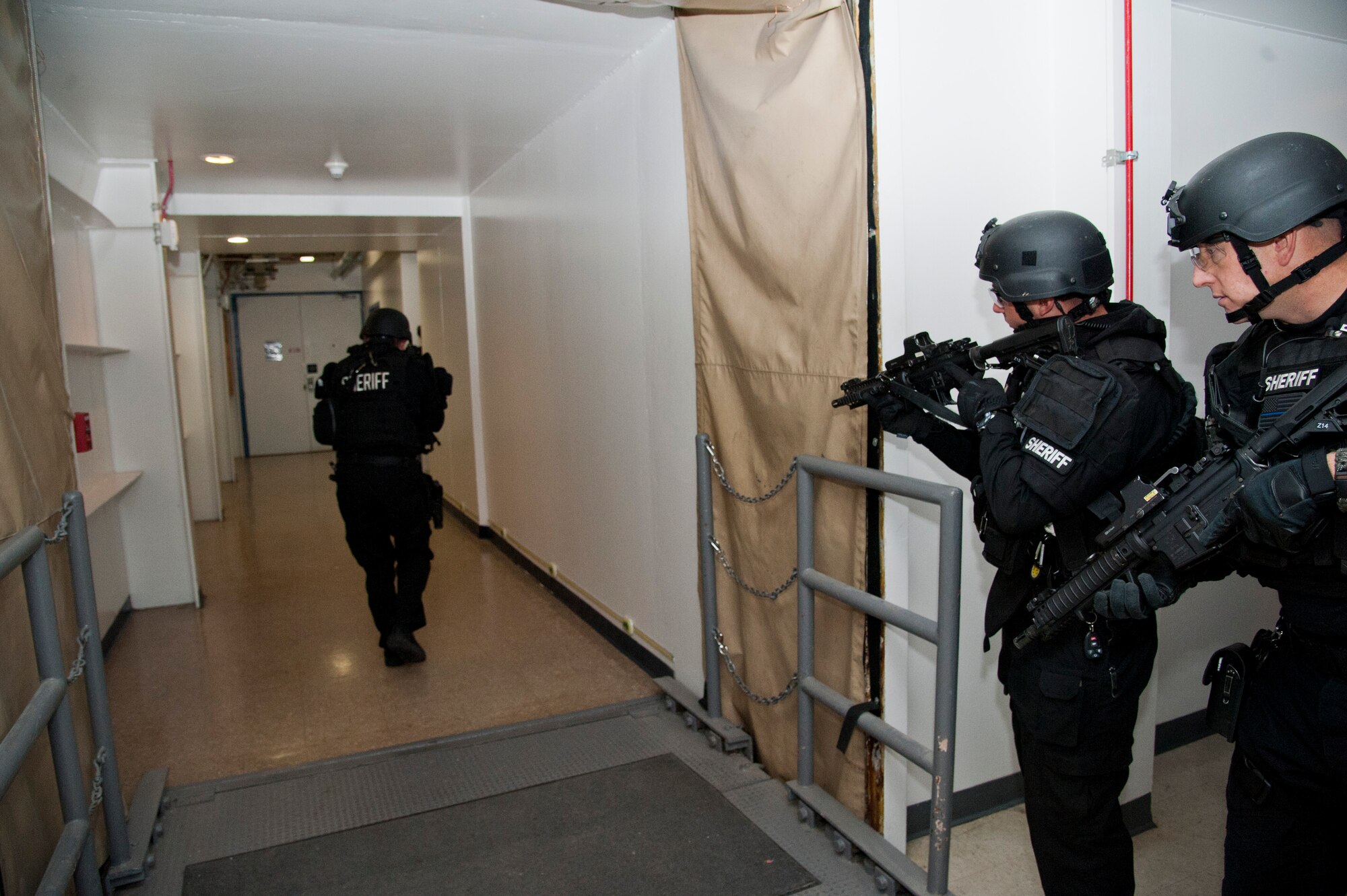 CHEYENNE MOUNTAIN AIR FORCE STATION, Colo. – El Paso County Sheriff’s Swat Team monitors the outside of a mission center during an active shooter turned hostage exercise scenario in Cheyenne Mountain Air Force Station’s underground complex, Oct. 22, 2015. The joint exercise was intended to evaluate the partnership between Cheyenne Mountain AFS personnel and El Paso County Sheriff’s office in a training environment in preparation for future potential real world situations. (U.S. Air Force photo by Senior Airman Tiffany DeNault)