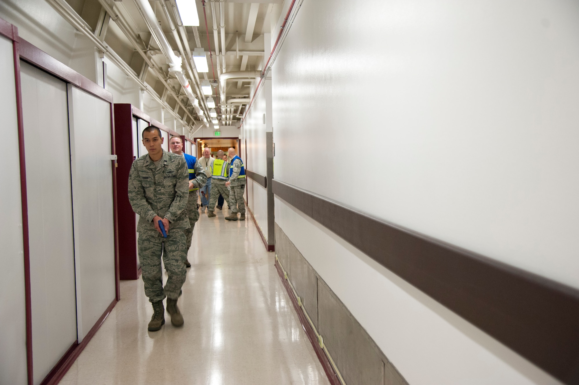 CHEYENNE MOUNTAIN AIR FORCE STATION, Colo. – First Lt. Miles Tran, simulated active shooter, roams the halls of Cheyenne Mountain Air Force Station underground complex leaving mock victims during an exercise, Oct. 22, 2015. Part of the exercise was intended to overwhelm the medical staff into a triage situation with simulated victims scattered along the complex’s hallways. (U.S. Air Force photo by Senior Airman Tiffany DeNault)