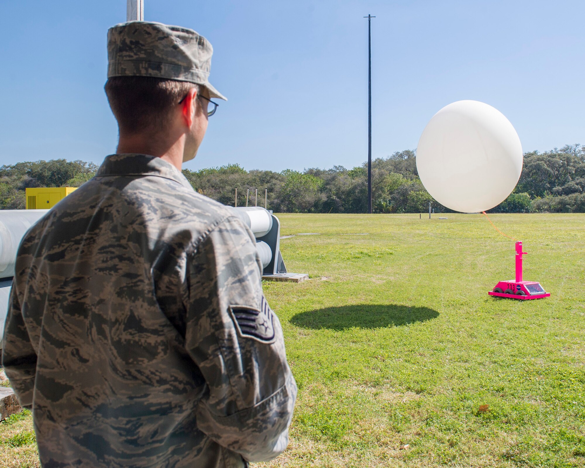Staff Sgt. Matthew Mong, 45th Weather Squadron NCO in charge training, demonstrates how to use, Pink, a Weather-Bot robot used to help members of the 45th WS release weather balloons without risking human life during lighting, Jan. 27, 2015, at Cape Canaveral Air Force Station, Fla. Many Brevard County students teamed-up with CCAFS and NASA to help better determine weather conditions during rocket launches.  (U.S. Air Force photo/Matthew Jurgens) (Released)  