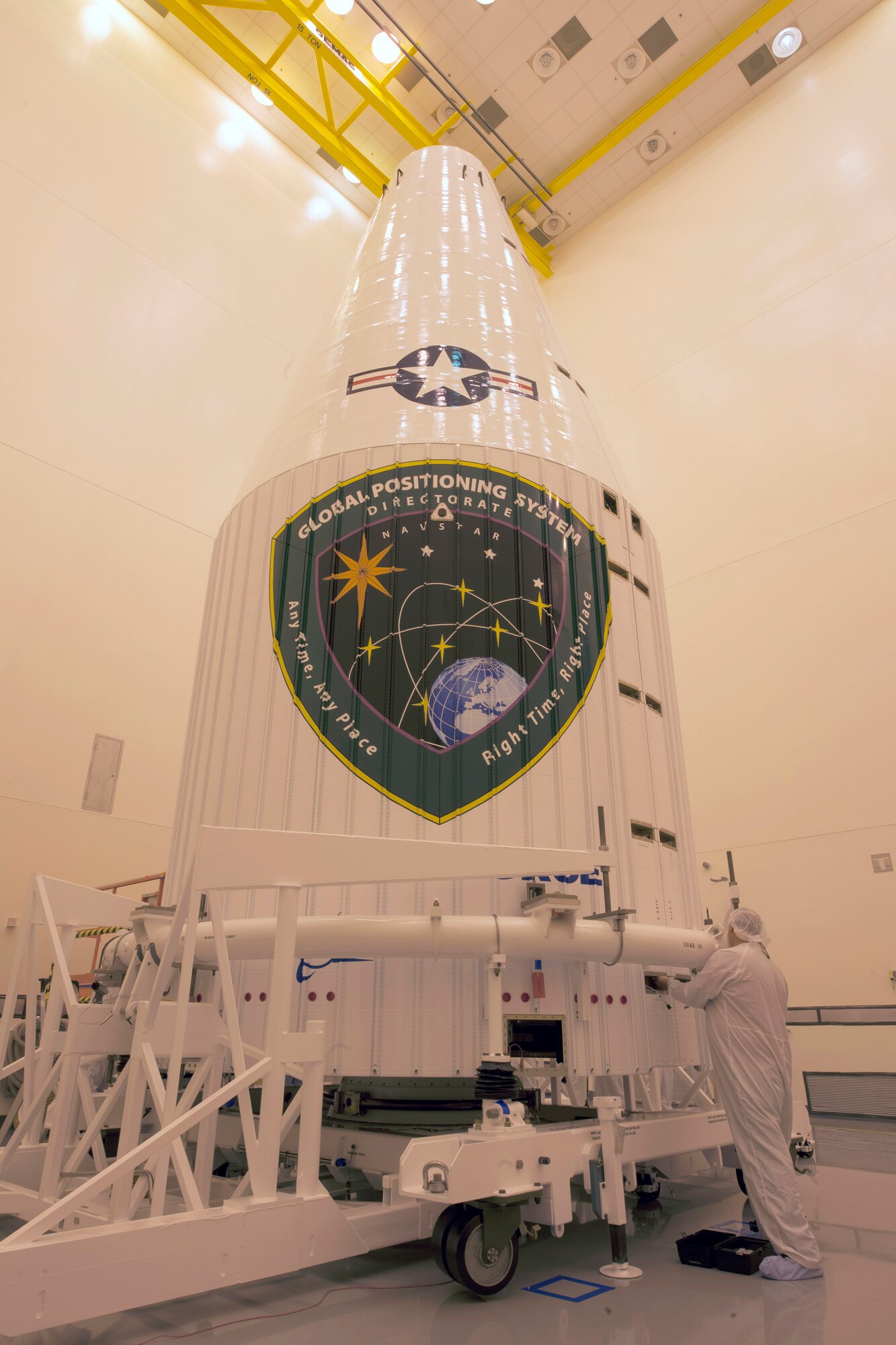 A technician performs a check of a Global Positioning System IIF-series satellite within a four-meter diameter protective payload fairing during final encapsulation Oct. 16 at Cape Canaveral Air Force Station, Fla. GPS IIF satellites provide improved signals that will enhance the precise global positioning, navigation and timing services supporting both the warfighter and the growing civilian needs of our global economy. GPS IIF will provide improved navigational accuracy through advanced atomic clocks, a longer design life than previous GPS satellites, and a third operational civil signal (L5) that benefits commercial aviation and safety-of-life applications. The Air Force and its mission partners are scheduled to launch GPS IIF-11 aboard a United Launch Alliance Atlas V 401 launch vehicle Oct. 30 from Space Launch Complex 41 at Cape Canaveral AFS, Fla. The launch window opens at 12:17 p.m. EDT and will remain open for 18 minutes. (Courtesy photo: United Launch Alliance)  