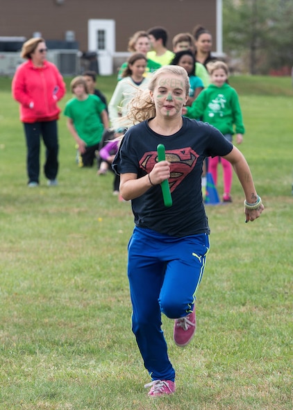 Lacie Adams, a Hanscom Middle School eighth-grader, runs her leg of a relay race during the school’s annual fall field day on base Oct. 23. Middle school students participated in games and activities as part of the event. (U.S. Air Force photo by Mark Herlihy)