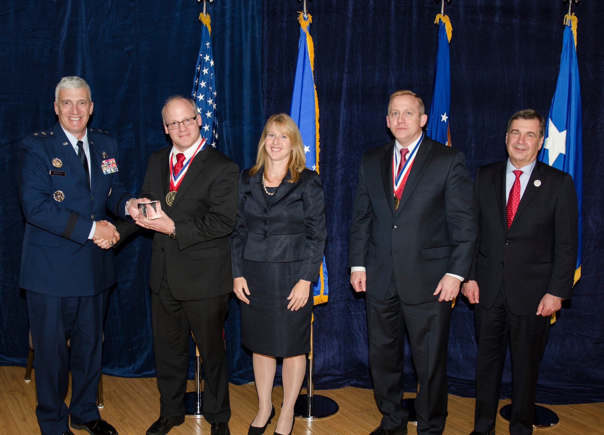Dr. Mark Linderman, the Division Technical Advisor to the Computing and Communications Division for the Information Directorate, was inducted into the AFRL Fellows Program on October 22, at the 2015 Fellows Ceremony, which took place at the Wright-Patterson Club. Pictured from left to right are AFRL Commander Maj. Gen. Thomas Masiello, Dr. Mark Linderman, Mrs. Linderman,  AFRL Chief Technologist Dr. Morley Stone and Air Force Chief Scientist Dr. Greg Zacharias. (U.S. Air Force photo/Michael Huber)