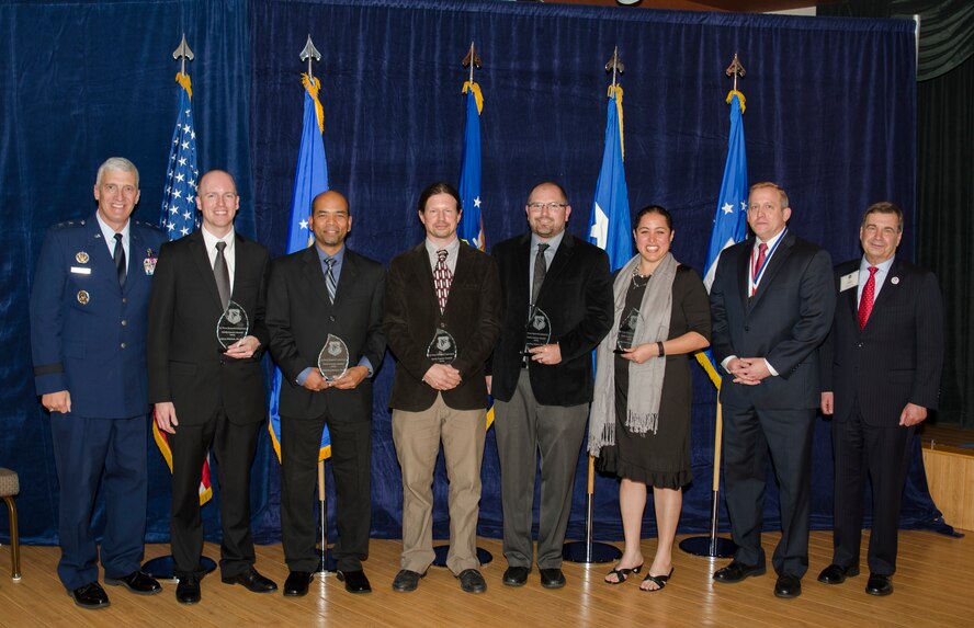 The most promising young scientists and engineers were honored on October 22, at the 2015 Fellows Ceremony with the Early Career Award for both their leadership potential and their mission contributions made within the first 5 years of their research careers. Pictured left to right are AFRL Commander Maj. Gen. Thomas Masiello, Dr. Adam Pilchak, Dr. Wellesley Pereira, Dr. Joshua Hendrickson, Dr. Josh Hagen, Dr. Rachel Abrahams, AFRL Chief Technologist Dr. Morley Stone, and Air Force Chief Scientist Dr. Greg Zacharias. (U.S. Air Force photo/Michael Huber)