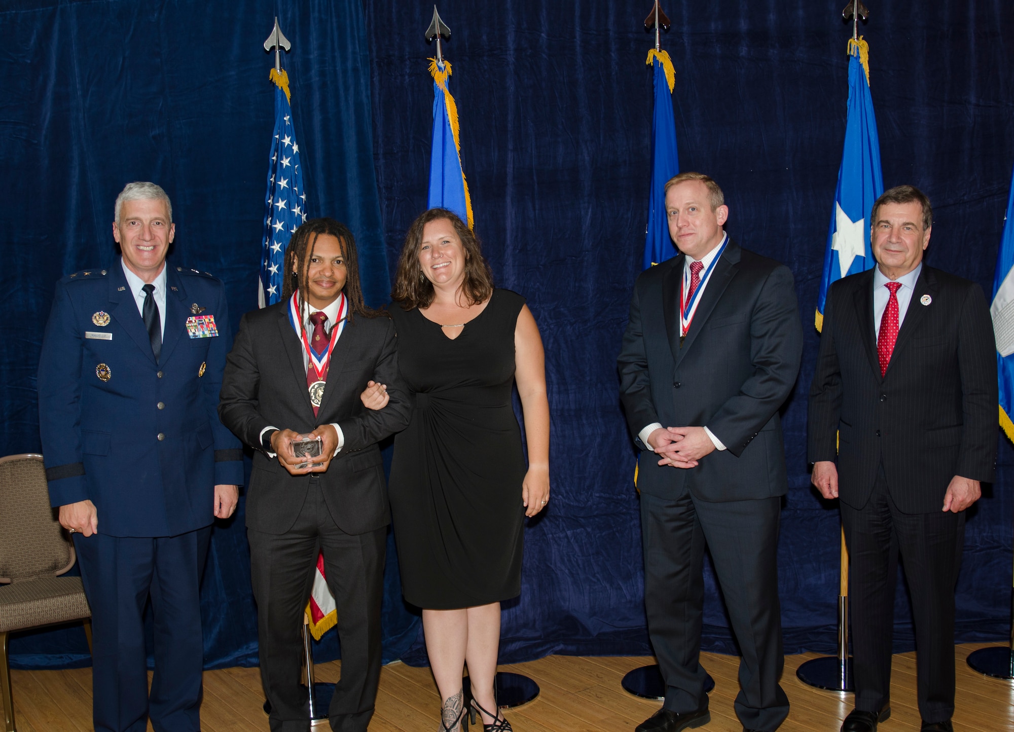 Dr. Moriba Jah, Principal Investigator for the Directed Energy Directorate, was inducted into the AFRL Fellows Program on October 22, at the 2015 Fellows Ceremony, which took place at the Wright-Patterson Club. Pictured from left to right are AFRL Commander Maj. Gen. Thomas Masiello, Dr. Moriba Jah, Mrs. Jah, AFRL Chief Technologist Dr. Morley Stone and Air Force Chief Scientist Dr. Greg Zacharias. (U.S. Air Force photo/Michael Huber)