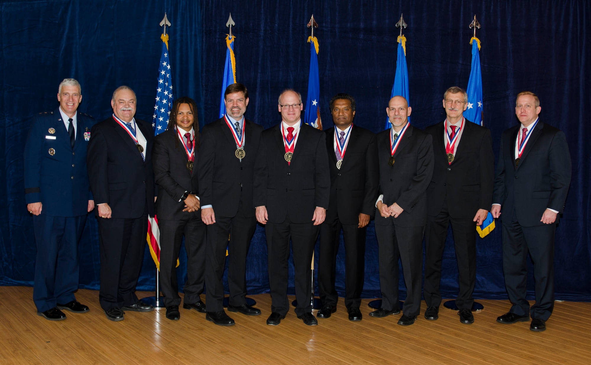 The most outstanding researchers representing the top 0.2 percent of AFRL technical professionals stand for a photo after being formally inducted into the prestigious ranks of the Fellows Program on October 22. Pictured from left to right are AFRL Commander Maj. Gen. Thomas Masiello, Mr. Kevin Slimak, Dr. Moriba Jah, Dr. Robert Murphey, Dr. Mark Linderman, Dr. Reji John, Dr. Raymond Kolonay, Mr. Byron Edmonds, and AFRL Chief Technologist Dr. Morley Stone. (U.S. Air Force photo/Michael Huber)