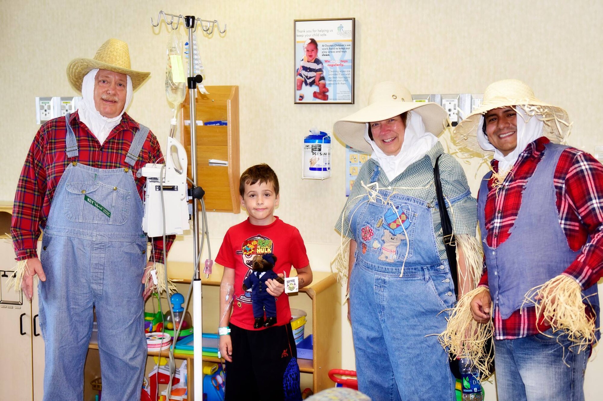 Air Force Research Laboratory small business personnel, Bruce Miller, Cynthia Bryant and Oswaldo Delacruz gave an Air Force bear to one of the patients from Dayton Children's Hospital. (U.S. Air Force photo/Abby Boggs)
