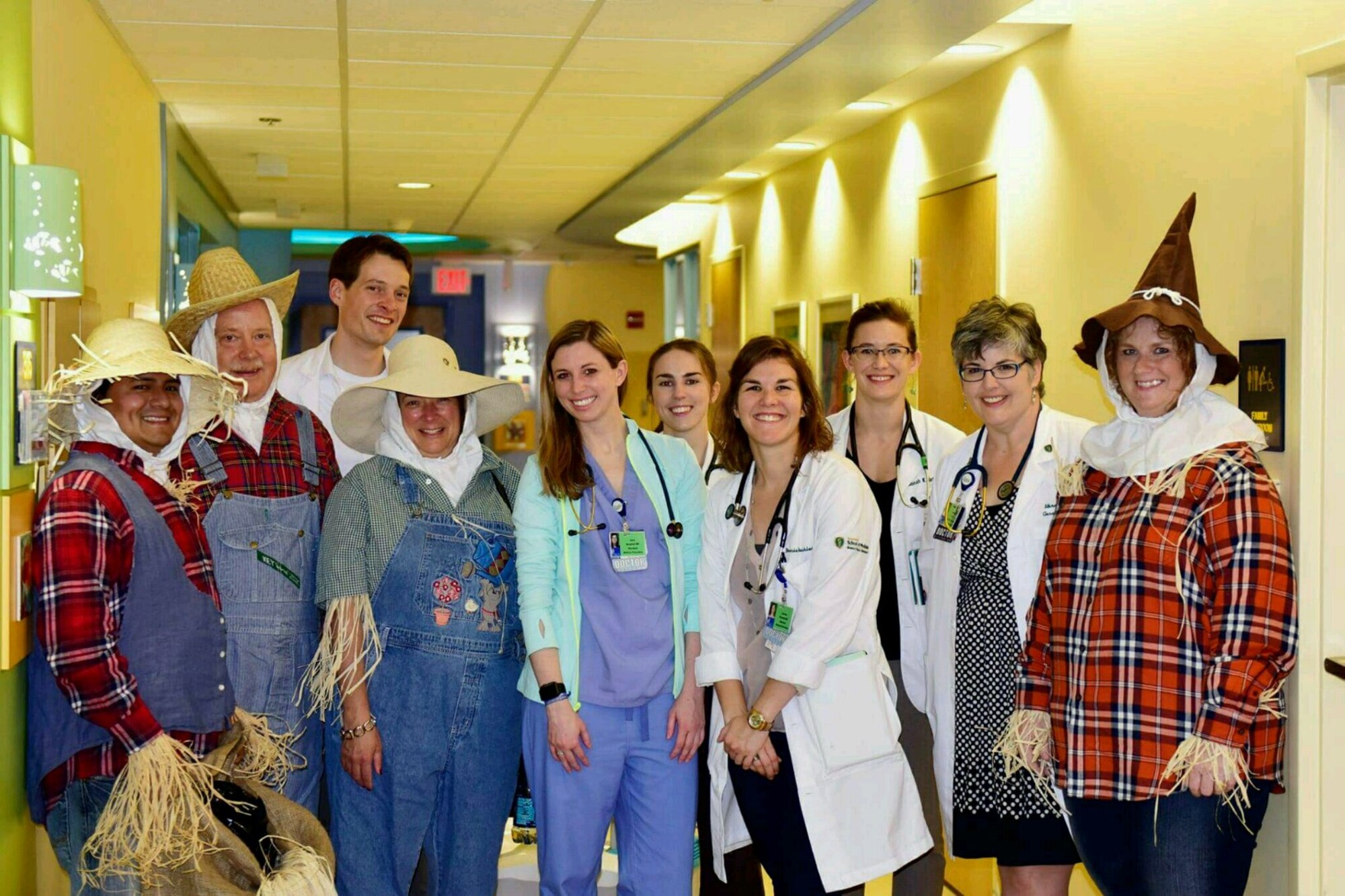The Air Force Research Laboratory small business personnel, dressed as scarecrows, stand with Dayton Children's Hospital staff, during their pre-Wingman Event. The scarecrows are from the left are Oswaldo Delacruz, Bruce Miller (Deputy Director), Cynthia Bryant and Tricia Randall. (U.S. Air Force photo/Abby Boggs)
