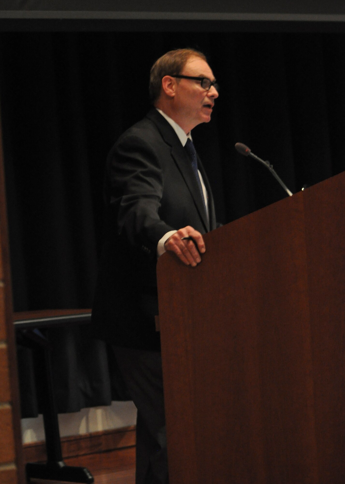 Greg Hannon, U.S. Air Force Expeditionary Operations School Registrar Division chief, speaks during the Battle of the Bulge symposium held at the U.S. Air Force Expeditionary Center Oct. 21, 2015. World War II veterans Lt. Col. (ret.) Bob Hansen and John Schaffner spoke about their experiences during WWII and watched the Emmy Award winning documentary Searching for Augusta: The Forgotten Angel of Bastogne. (U.S. Air Force Photo/Capt. Matthew Chism)