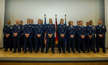 The graduating class 16-1 of the base Honor Guard’s training course pose for a photo after their graduation ceremony inside the base theater at Spangdahlem Air Base, Germany, Oct. 23, 2015. Twelve of the original 20 recruits completed and graduated the ceremony after five days of training. (U.S. Air Force photo by Airman 1st Class Timothy Kim/Released)
