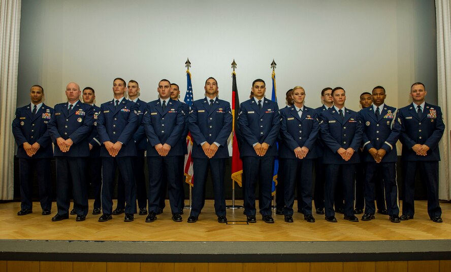 The graduating class 16-1 of the base Honor Guard’s training course pose for a photo after their graduation ceremony inside the base theater at Spangdahlem Air Base, Germany, Oct. 23, 2015. Twelve of the original 20 recruits completed and graduated the ceremony after five days of training. (U.S. Air Force photo by Airman 1st Class Timothy Kim/Released)