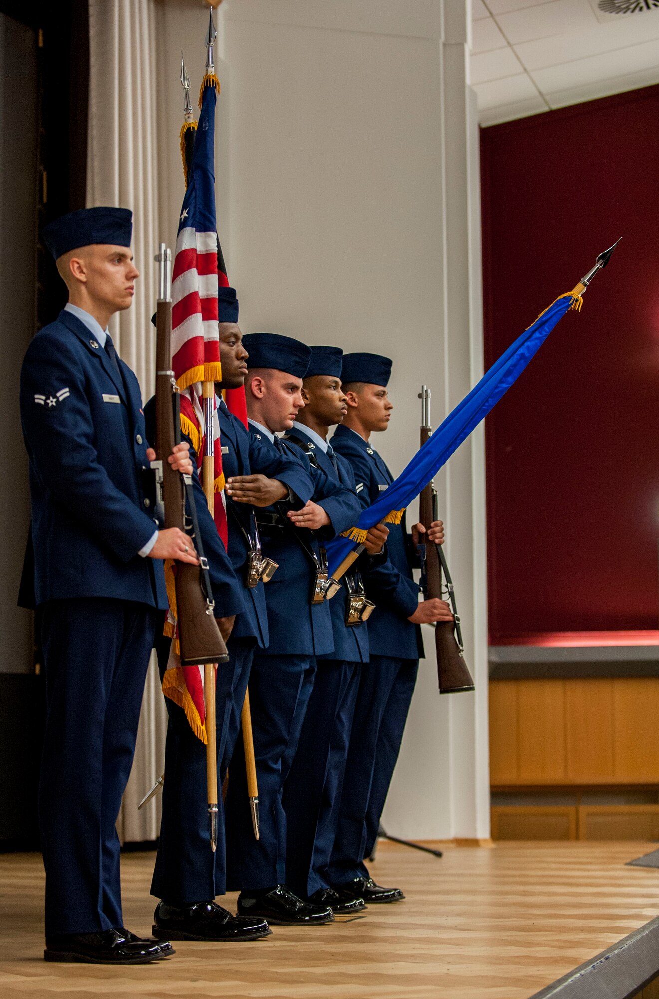 Members of the Honor Guard’s training course graduating class 16-1, present the colors before the graduation ceremony inside the base theater at Spangdahlem Air Base, Germany, Oct. 23, 2015. The ceremonial guardsmen spent more than 40 hours mastering formal movements required for their new duties. (U.S. Air Force photo by Airman 1st Class Timothy Kim/Released)