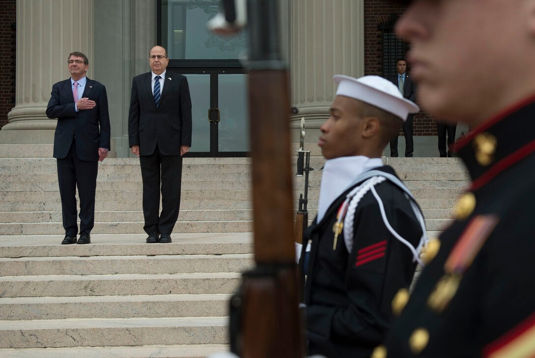 U.S. Defense Secretary Ash Carter and Israeli Defense Minister Moshe Yaalon render honors for the playing of the national anthems of their countries at National Defense University, Washington, D.C., Oct. 27, 2015. Both leaders spoke to a class of U.S. and international students and met to discuss matters of mutual importance. DoD photo by Air Force Senior Master Sgt. Adrian Cadiz