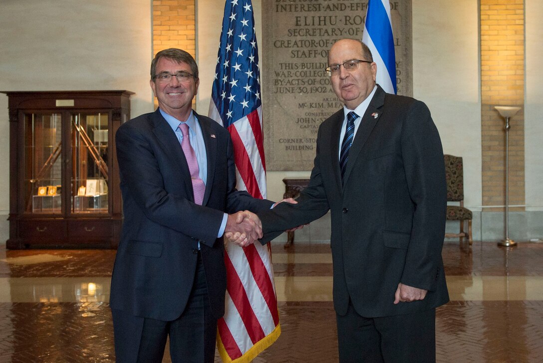 U.S. Defense Secretary Ash Carter and Israeli Defense Minister Moshe Yaalon pose for a photo as they shake hands at National Defense University, Washington, D.C., Oct. 27, 2015. Both leaders spoke to a class of U.S. and international students and met to discuss matters of mutual importance. DoD photo by Air Force Senior Master Sgt. Adrian Cadiz