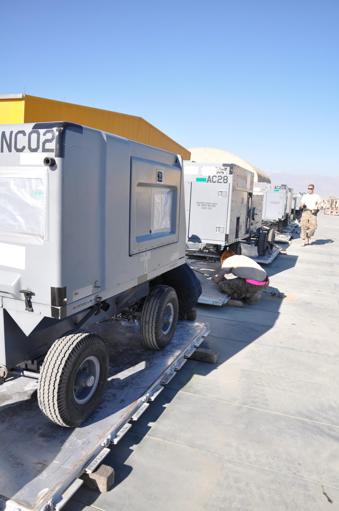 Tech. Sgt. Matthew Adelman, 455th Expeditionary Maintenance Squadron AGE flight NCO in charge, and Tech. Sgt. Ann Gwaltney, 455th EMXS AGE flight technician, both deployed from Aviano Air Base, Italy,  inspect pieces of deployed equipment Oct. 27, 2015, at Bagram Airfield, Afghanistan. The AGE flight is responsible for the maintenance and inspection of 309 pieces of equipment used on the flight line and around base. (U.S. Air Force photo by Tech. Sgt. Nicholas Rau/Released)