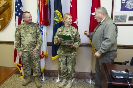 Mark Brooks (right), U.S. Army Reserve Command’s Chief, Antiterrorism Branch, talks to Capt. Wendy Nelson about her pivotal role in the success of the U.S. Army Civil Affairs and Psychological Operations Command (Airborne) antiterrorism program the presentation of the 2014 USARC’s Best Antiterrorism Program during a ceremony held Oct. 26 at Fort Bragg, N.C. Nelson is the command’s antiterrorism program manager. (Army Reserve photo by Master Sgt. Mark Bell/released)