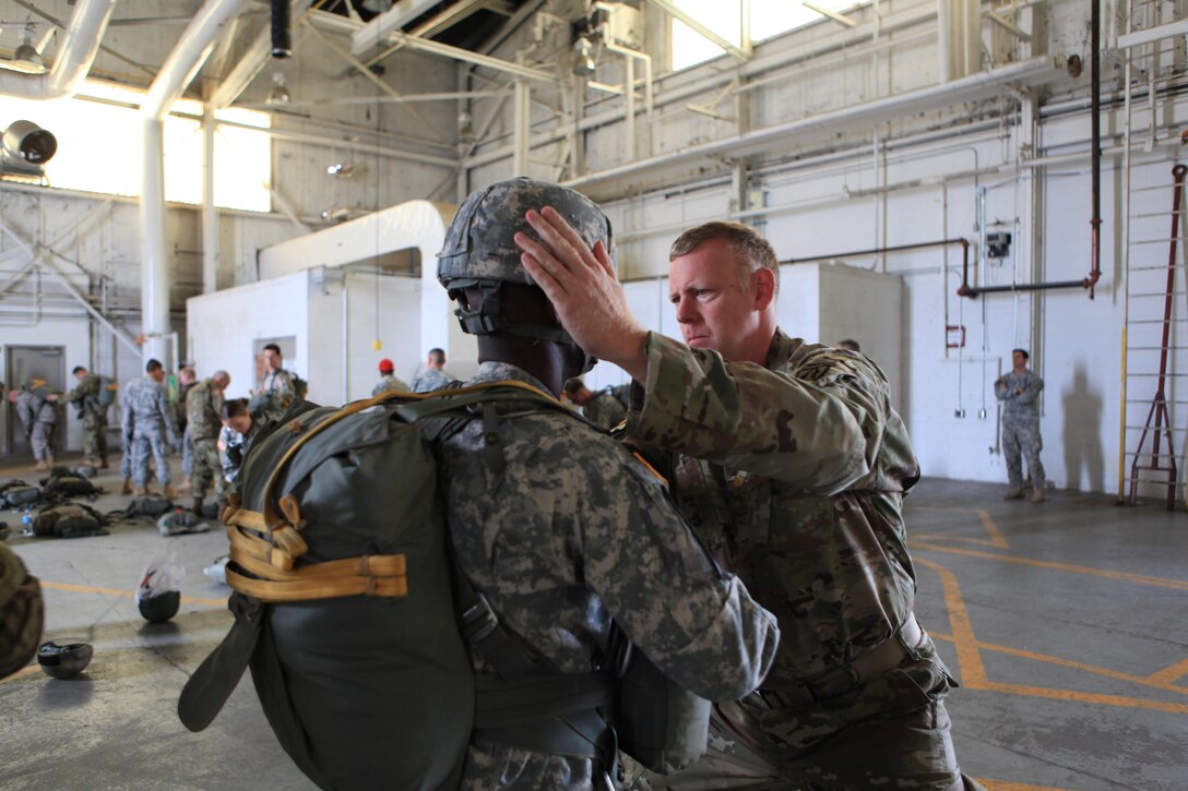 U.S. Army Maj. Cristopher D. Murphy, Commander of the 982nd Combat Camera Signal Co. performs a jumpmaster inspection of jumper during airborne operations at Fort Bragg, N.C., Oct. 26, 2015. Maj. Murphy is a guest jumper with U.S. Army Civil Affairs and Psychological Operations Command, as they conduct airborne operations in order to maintain proficiency and receive familiarization with the C-27 aircraft. Photo by Sgt. 1st Class Sean A. Foley (Released)