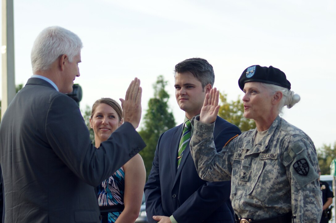 Retired U.S. Air Force Col. Jon Link administers the Oath of Office to his sister, newly promoted U.S. Army Reserve Maj. Gen. Mary E. Link, the Army Reserve Medical Command commanding general, during her promotion ceremony Sept. 26, 2015, at the C.W. Bill Young Armed Forces Reserve Center in Pinellas Park, Fla. Link received her promotion prior to becoming the fifth commanding general of ARMEDCOM in a subsequent ceremony held the same day. (U.S. Army photo Staff Sgt. Kelvin Squires/Released)