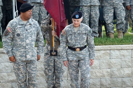 The incoming command team for the Army Reserve Medical Command, Command Sgt. Maj. Marlo V. Cross, a Tempe, Ariz., resident, and Maj. Gen. Mary. E. Link, of Ravenna, Neb., finish uncasing the commanding general’s individual flag after Link’s promotion ceremony held just prior to the ARMEDCOM change of command ceremony Sept. 26, 2015 at the C.W. Bill Young Armed Forces Reserve Center in Pinellas Park, Fla. Link became the fifth commander and first woman in the ten year history of the unit to take command.